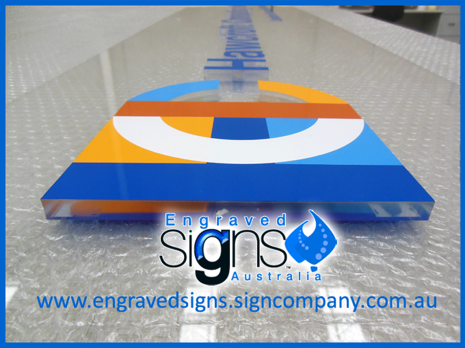 The sign makers photo of multi color logo sign with clear plastic letters and color face of blue, orange and terracotta. This is a beautiful sign